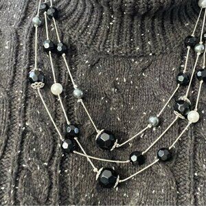 white and bluish Fau pearls and black beads on three strand